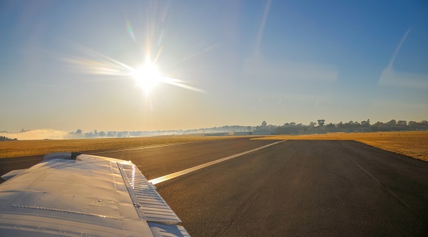 Plane Wing And Runway At Sunrise